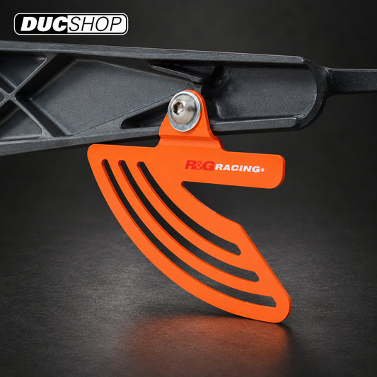 Orange R&G toe and chain guard installed at a swingarm mount; representative finish for TG0011BK Black | ducshop.com
